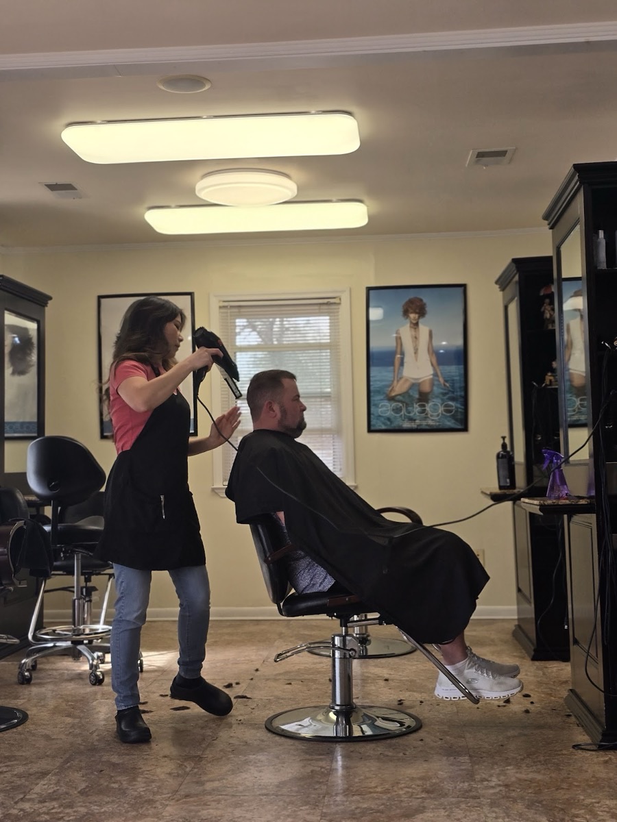 Holly blow-drying a client in the bright, welcoming salon