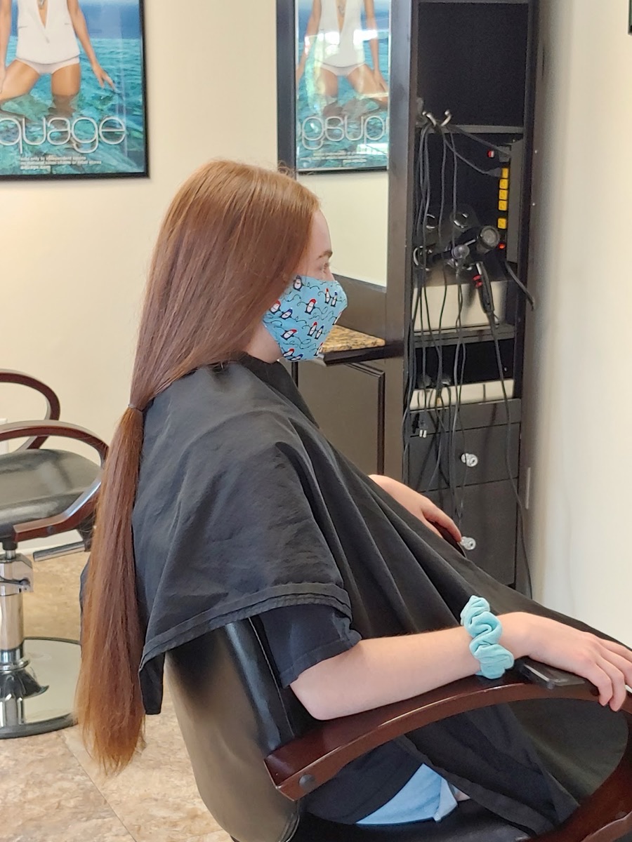 Long, sleek auburn hair styled to a smooth, glossy finish
